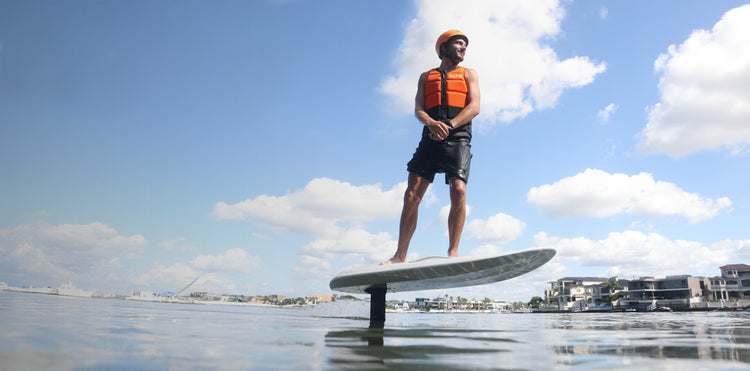 Rider standing on a Fliteboard eFoil above the water