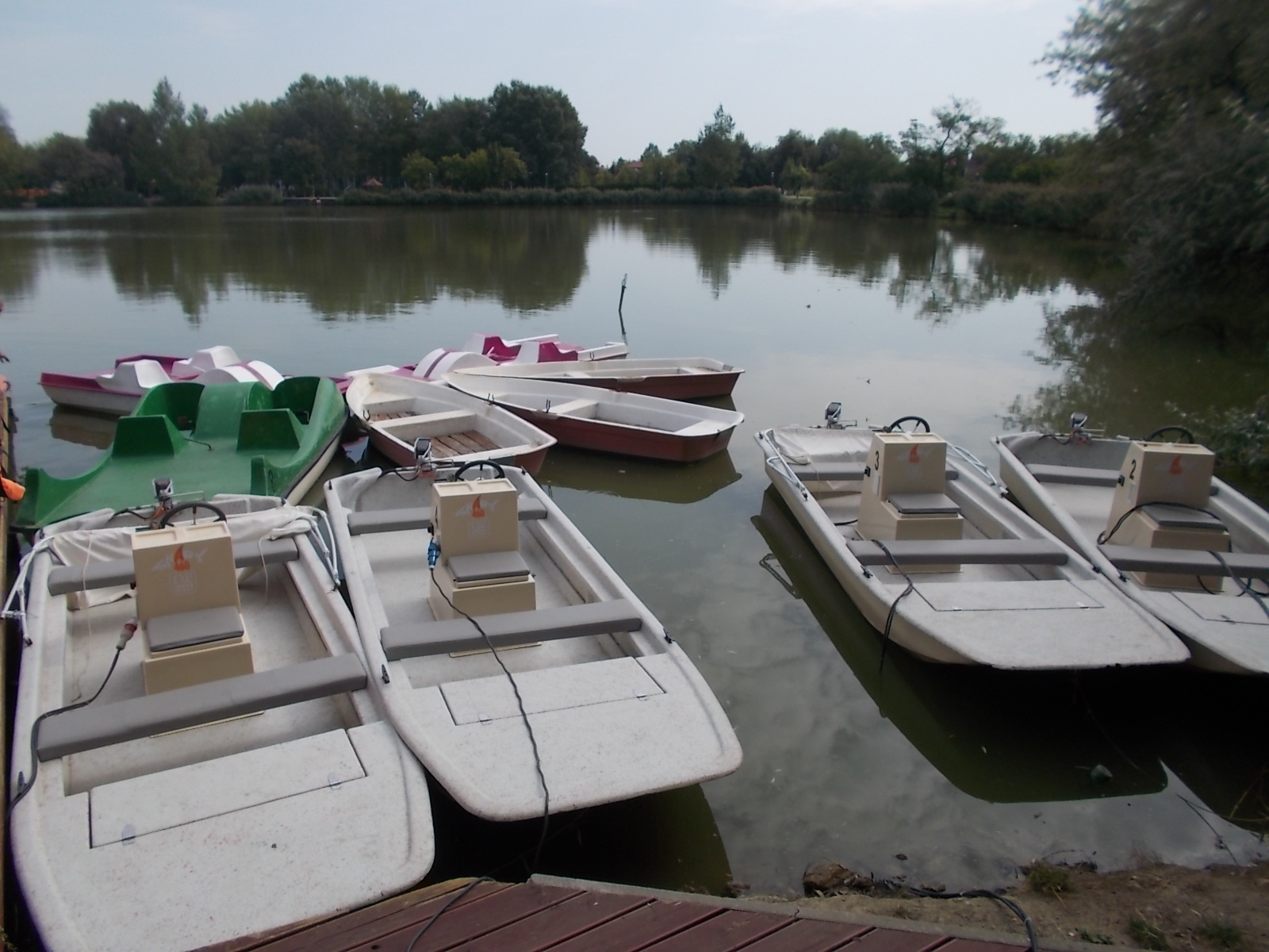 Rental electric motor boats at a lake pier in Hungary