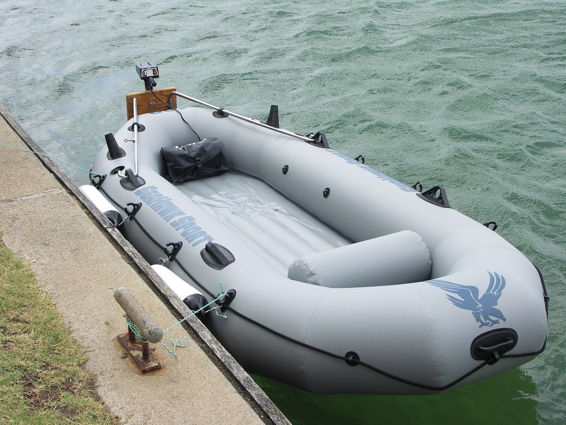 PVC inflatable boat with small electric trolling outboard motor